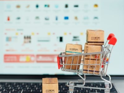 Boxes with shopping cart on a laptop computer. online shopping, Marketplace platform website, technology, ecommerce, shipping delivery, logistics and online payment concepts